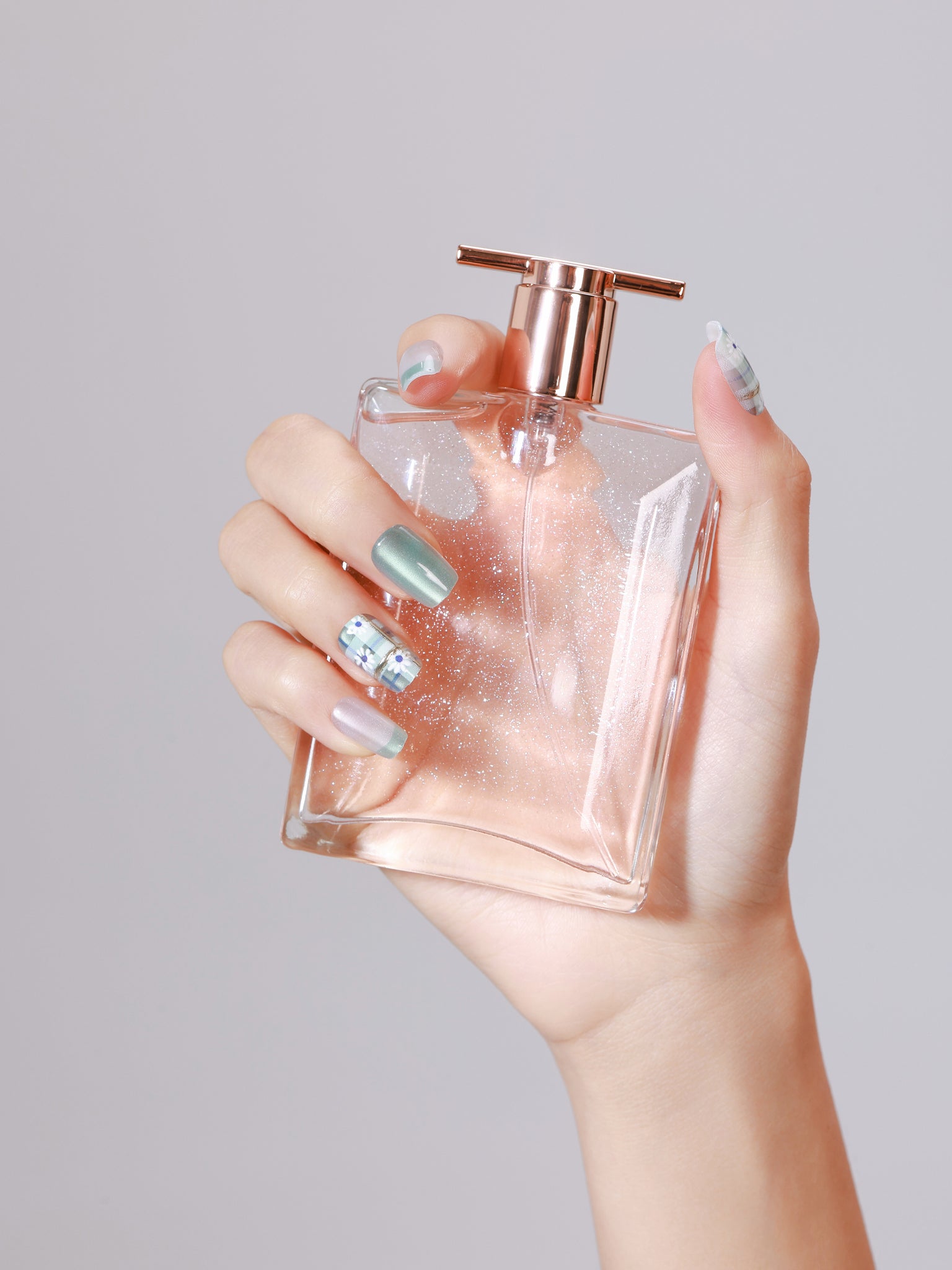 Short square mint shimmer and pearly white press-on nails with green plaid daisy accent nails