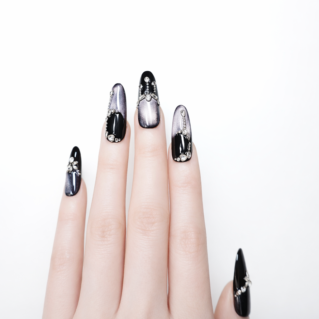 black and metallic purple almond press-on nails with silver rhinestone bow and chain details