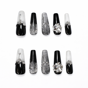 Set of black and silver coffin press on nails featuring glitter ombre, rhinestone details, metallic texture and 3D crystal flower accent
