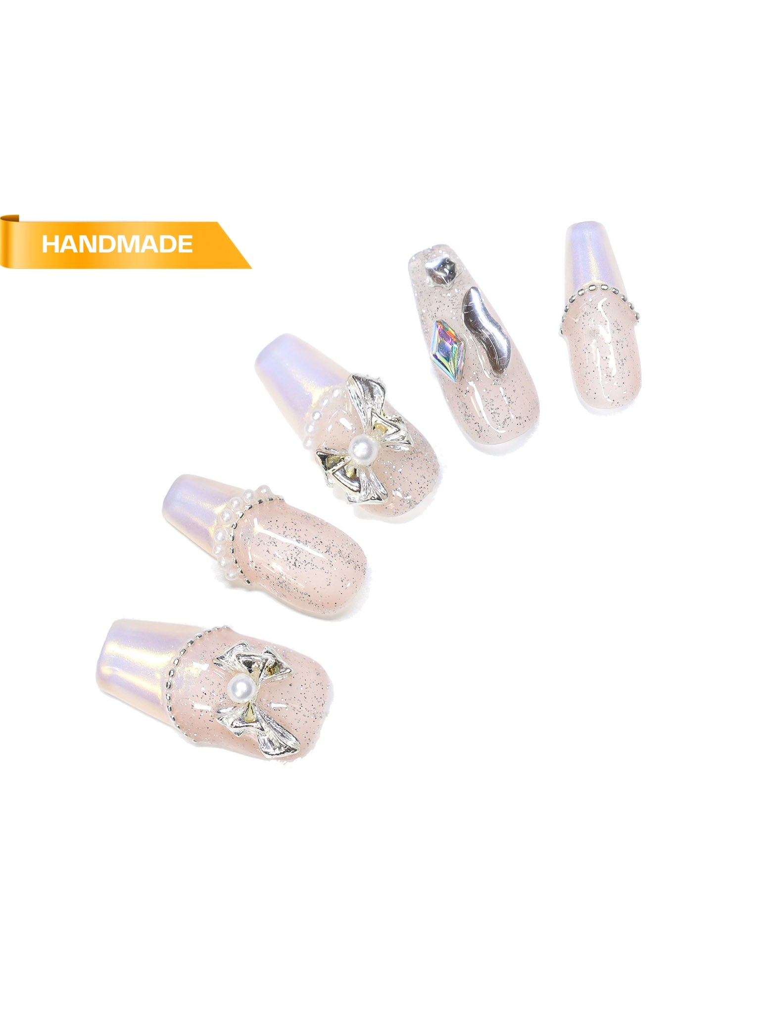 Long coffin press on nails featuring clear glitter overlay, pearlescent chrome tips, pearl beads, metallic bow charms, and crystal accents in close up