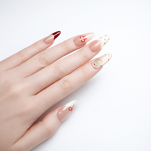 Hand model wearing nude ombre almond press on nails with red bow French tips, glossy finish and elegant minimalist nail art
