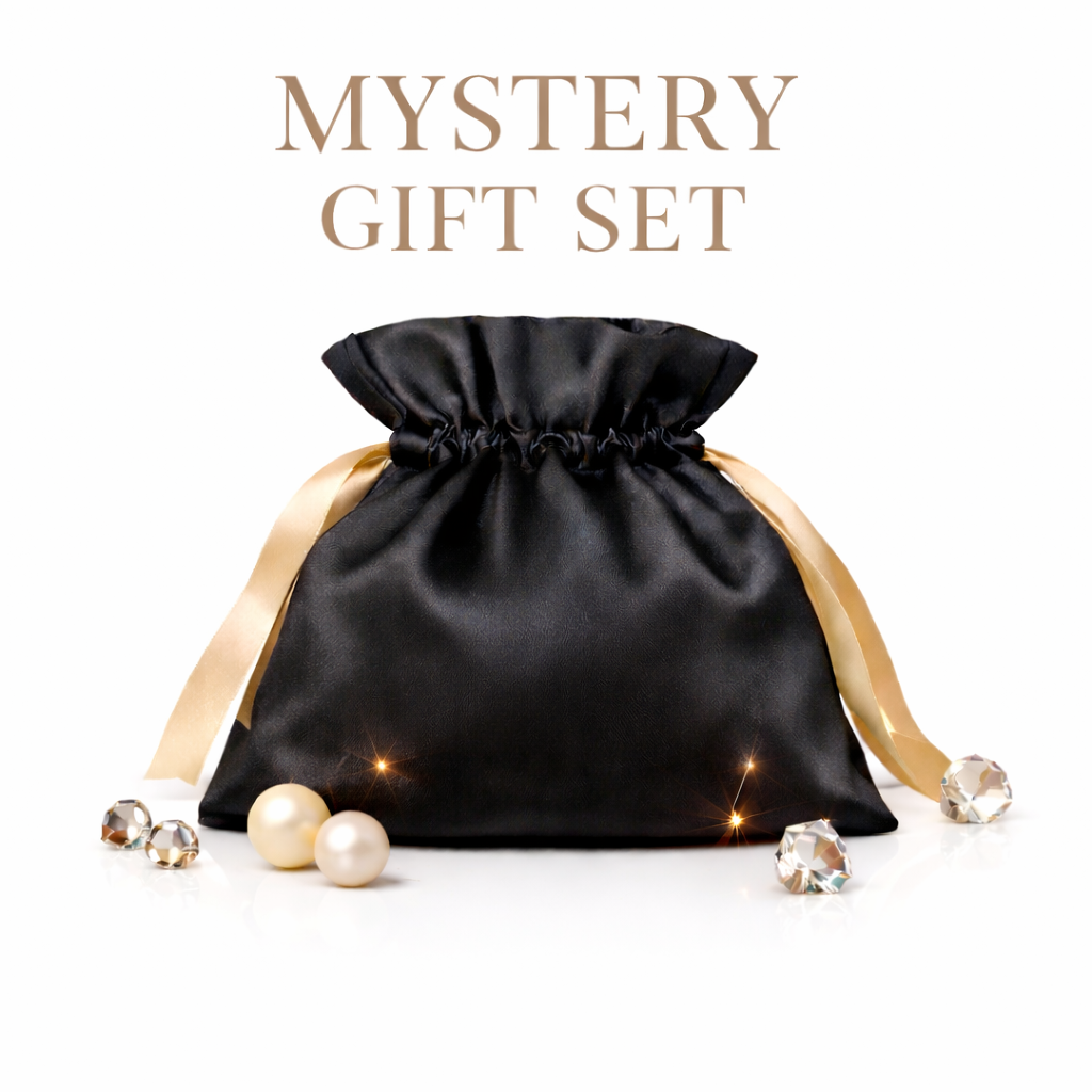 Black satin mystery gift set pouch with champagne ribbons on a white background, styled with pearls and crystal accents, with “Mystery Gift Set” text above.