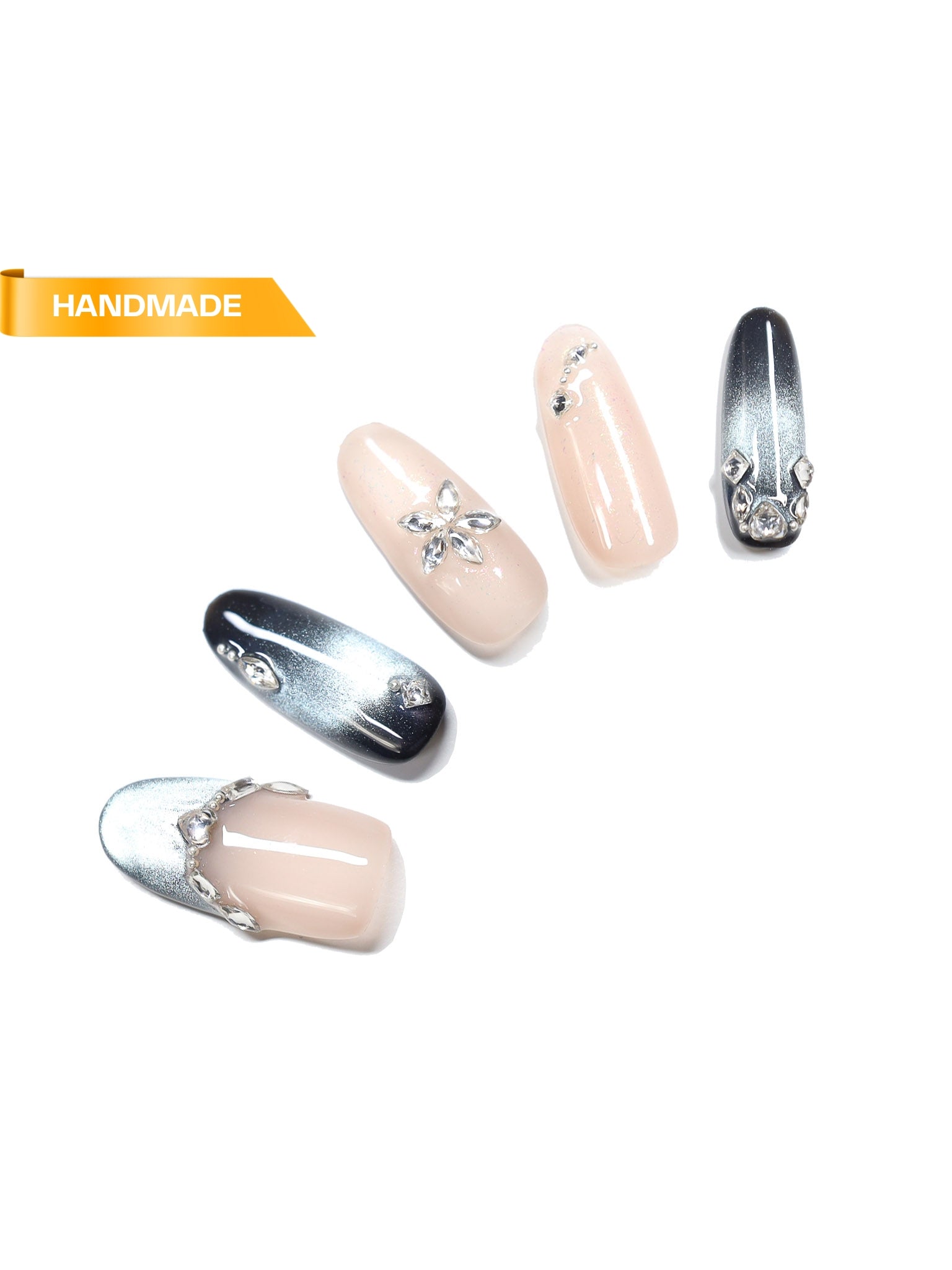 Handmade almond press-on nails in nude and silver chrome with rhinestone accents on white background